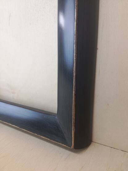 Widok narożnika ramy – wykończenie malarskie
Delikatne ślady pędzla na powierzchni ramy, uzyskane poprzez malowanie w dwóch odcieniach czerni.